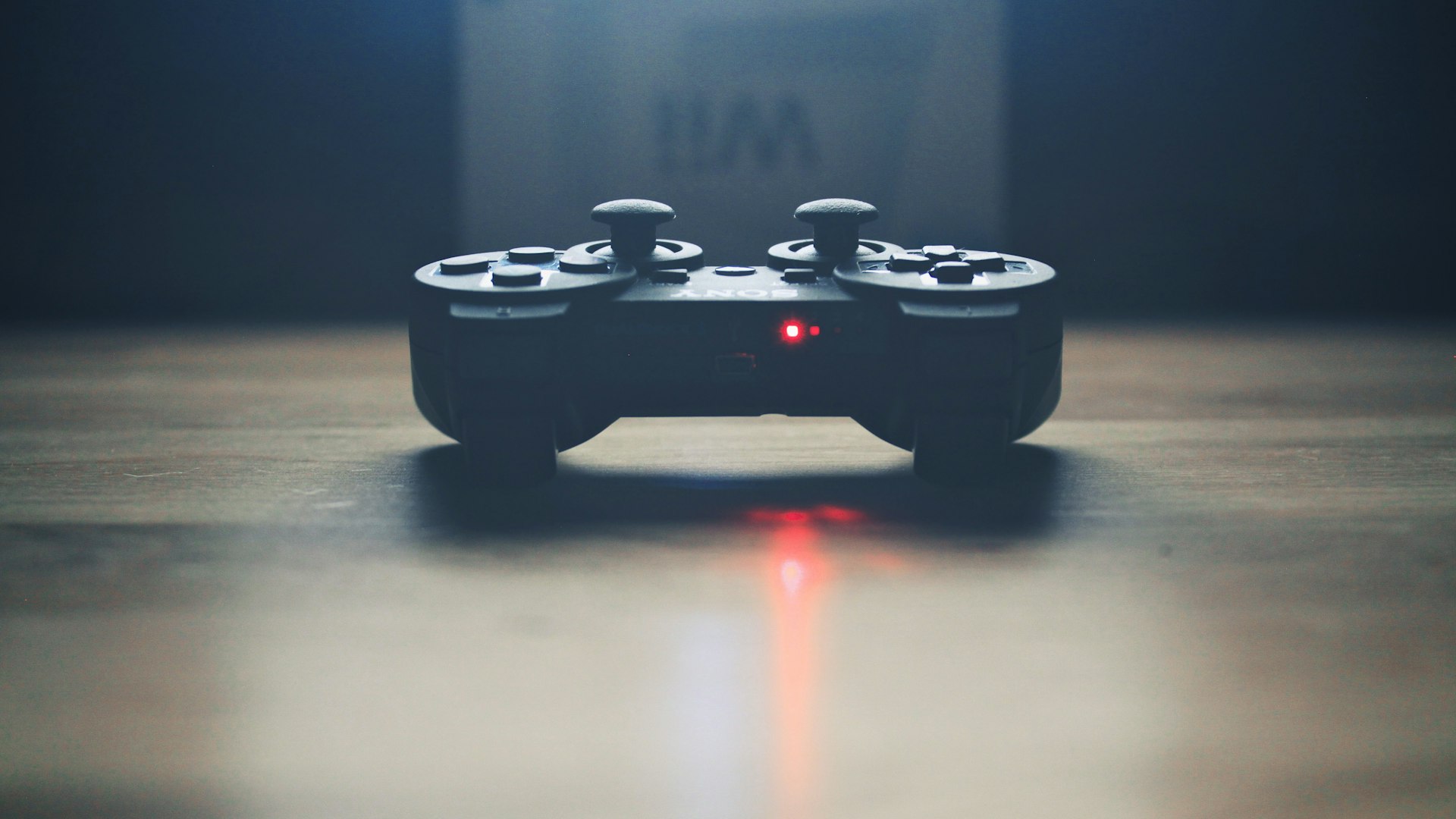 Neon-lit gaming setup with a mechanical keyboard and dungeon-crawler on screen